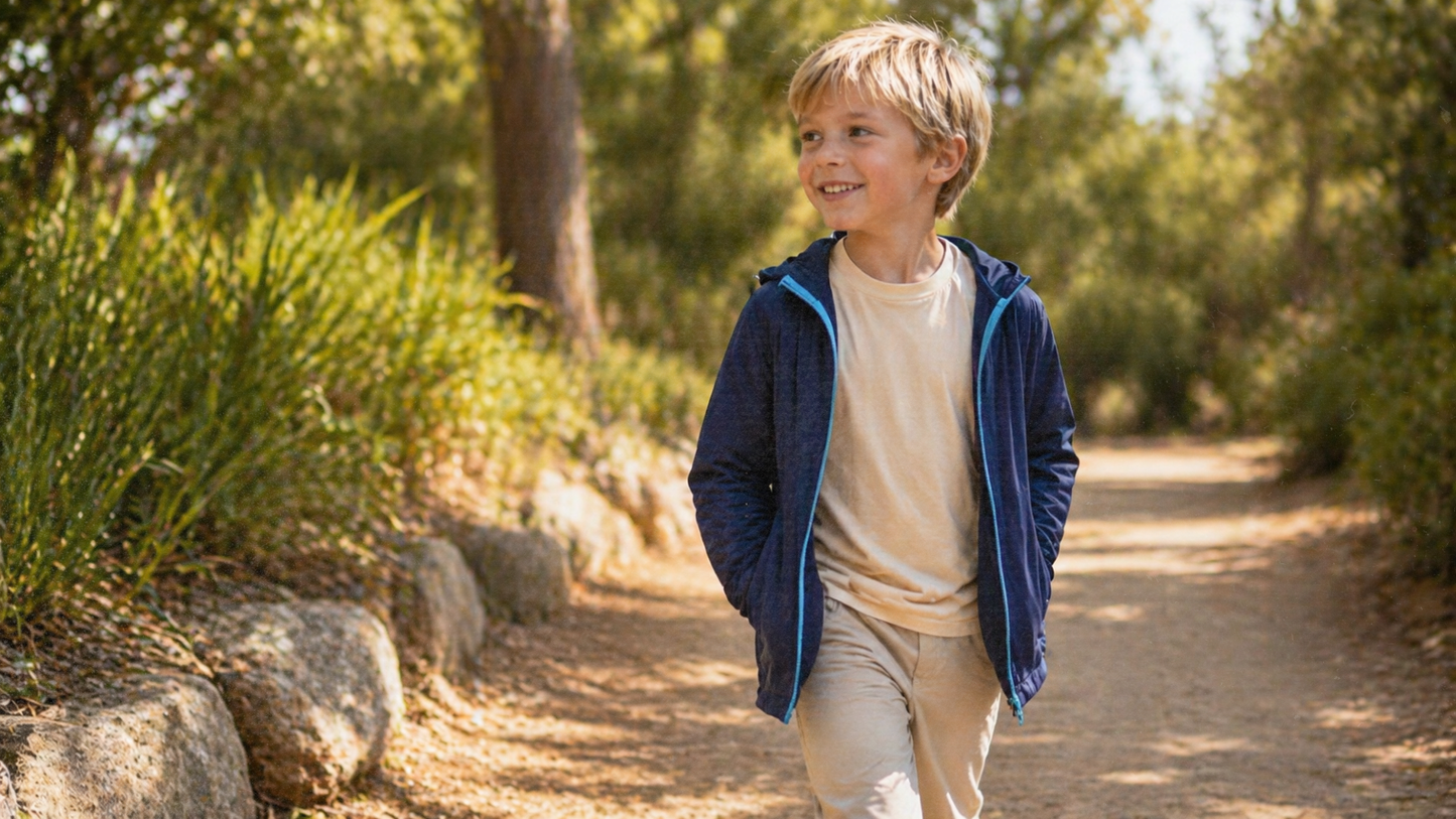 Child wearing Ember & Ray UPF 50+ clothing outdoors on a sunny day, showing everyday sun protective clothing for kids